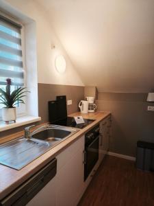 a kitchen with a sink and a counter top at Juliusruh Strandparadies 12 in Juliusruh