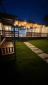 a pavilion with lights on the grass at night at Casa Paraíso de Alter in Santarém