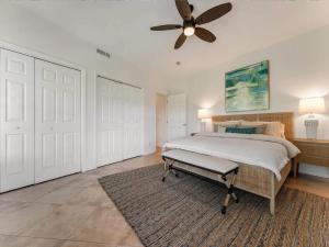 a bedroom with a bed and a ceiling fan at Elegant Waterfront Corner Residence in Key West