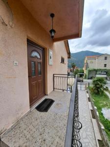 a front door of a house with a porch at Apartman Jadran Private Parking in Dobrota