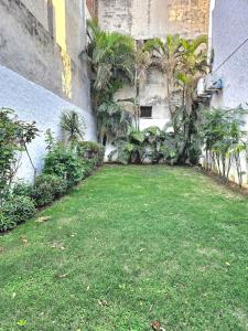 a yard with green grass and a building at The Green Villa in Ludhiana