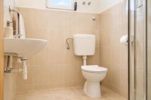 a bathroom with a toilet and a sink at Dana Apartments - Seafront Pašman in Pašman +25 photos