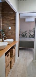 a bathroom with two sinks and a tub at chambres d'hôtes Les Fenières in Sainte-Croix-de-Verdon