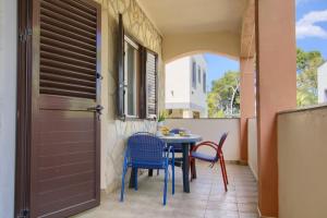 a patio with a table and chairs and a door at Dana Apartments - Seafront Pašman in Pašman