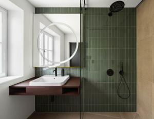 a bathroom with a sink and a mirror at Moe by Limehome in Freudenstadt