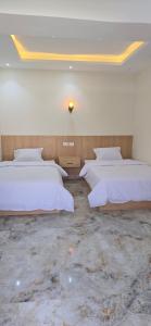 a bedroom with two beds in a room at Nakhil Pyramids Resort in Cairo