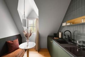 a kitchen with a vase of flowers on a table at Moe by Limehome in Freudenstadt +30 photos