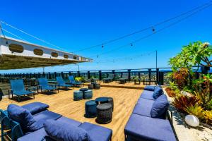 a patio with blue couches and chairs on a boat at Intercity Salvador in Salvador