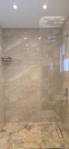 a shower with a glass door in a bathroom at Nakhil Pyramids Resort in Cairo
