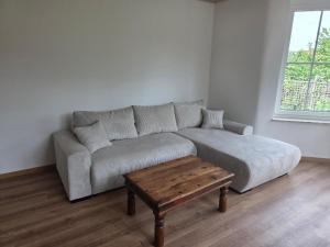 a living room with a couch and a coffee table at Monteuerwohnung in ruhiger Lage in Möser