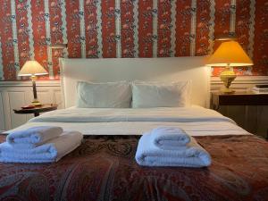 a bedroom with a bed with towels on it at La Suite de la Bastide in Val-de-Dagne