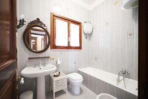 a bathroom with a sink toilet and a mirror at villa il sogno di Cosimo in Ravello +36 photos
