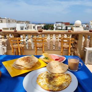 a blue table with two plates of food on it at Ira Hostel in Dahab