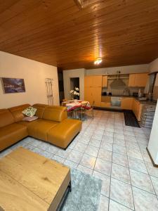a living room with a couch and a kitchen at Appartamenti Posse- Verzasca in Lavertezzo