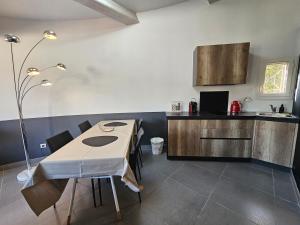 a kitchen with a table with chairs and a counter at Loft Casa Couderc Terrace Parking in Velaux