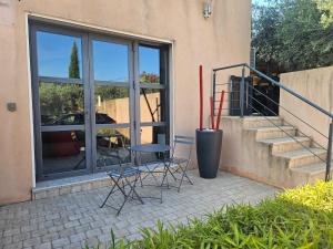 two chairs sitting on a patio next to a building at Loft Casa Couderc Terrace Parking in Velaux +5 photos