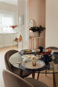a dining room table with plates of food on it at Castros Homes in Santander