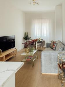 a living room with a couch and a table at Castros Homes in Santander
