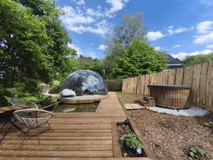 a backyard with a gazebo and a wooden deck at Dôme Renard by Out & Lodge in Couvin +13 photos