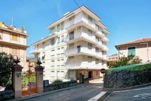 a tall white building on the side of a street at Casa La Perla in Rapallo