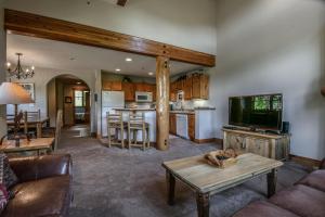 a living room with a couch a table and a kitchen at Trappers Crossing 8753 by SummitCove Lodging in Colorado in Keystone +34 photos
