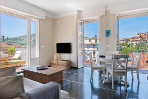 a living room with a table and a tv at Casa La Perla in Rapallo