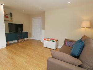a living room with a couch and a flat screen tv at Seaview Portland in Portland
