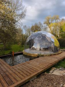 a dome with a cow inside of it on a bridge at Dôme Renard by Out & Lodge in Couvin