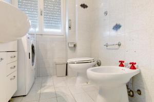 a white bathroom with a toilet and a sink at Casa La Perla in Rapallo +31 photos