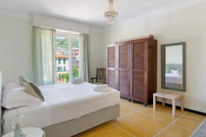 a bedroom with a bed and a large window at Casa La Perla in Rapallo
