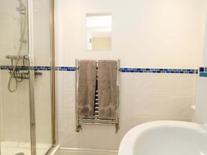 a bathroom with a shower and a sink and towels at Seaview Portland in Portland +19 photos
