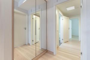 a mirror in a hallway with white walls and wooden floors at Mierki da Marco in Mörken