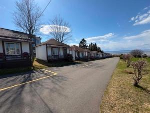 an empty street with a row of houses at Motel au Fleuve d'Argent in Rivière-du-Loup