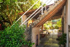 an outdoor patio with a stairway leading up to a building at Maraca Vibes Hostel in Porto De Galinhas