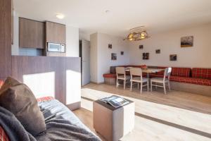 a living room with a couch and a table at Résidence Pierre & Vacances Atria-Crozats in Avoriaz +46 photos