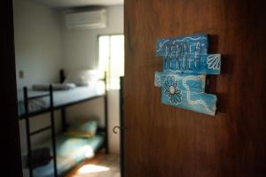 a door with a sign that says happy new year at Maraca Vibes Hostel in Porto De Galinhas