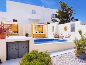 a villa with a pool and a house at Marina's Studios in Perivolos