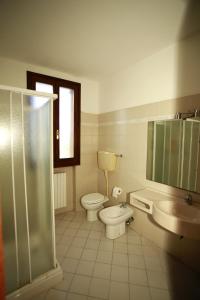 a bathroom with a toilet and a sink and a shower at Affittacamere San Cristoforo Faenza in Faenza