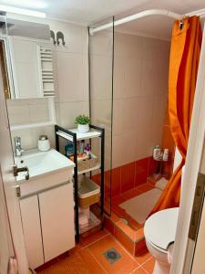 a bathroom with a shower and a sink and a toilet at 7th sky Aristotelous in Thessaloniki +96 photos