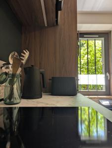 a kitchen counter with a counter top with a window at Les Chapeliers in Foix