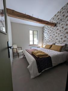 a bedroom with a large bed and a window at Les Chapeliers in Foix