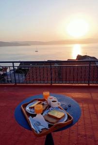 a tray of food on a table with drinks and toast at Albergue-Pensión Cabo da Vila in Finisterre
