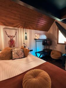 a bedroom with a large bed with a deer head on the wall at ISKÖ CHALETS-HÖTEL, Col d'Aubisque in Gourette +64 photos