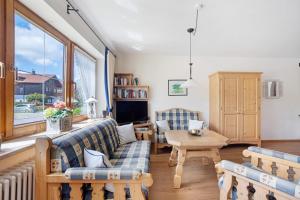 a living room with a couch and a table at Haus Grüntensee in Wertach