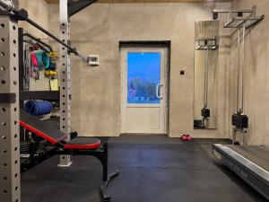 a gym with a door with a window and a bench at Galeria PRL in Borne Sulinowo