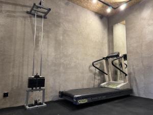 a gym with a treadmill in a room at Galeria PRL in Borne Sulinowo