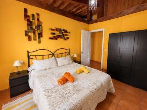 a bedroom with a bed with two stuffed animals on it at Los Tres Soles in Silleda