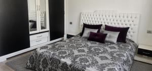 a bedroom with a large bed with purple pillows at Residence fedi in Monastir