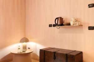 a room with a table with a candle and a wooden chest at Tenuta I Maroneri in Drena