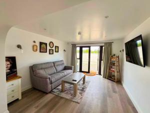 a living room with a couch and a table at Trelawney in Coleraine